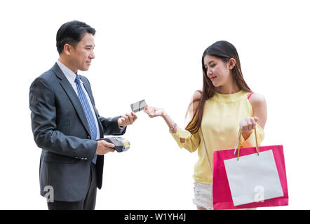 Asian woman paying credit card with payment terminal and cashier man on white background Stock Photo