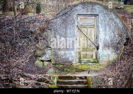 Door to the old concrete cold storage place. Stock Photo