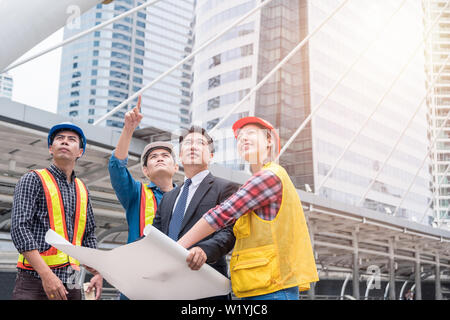 Engineer group with businessman meeting agreement for big project in the city Stock Photo