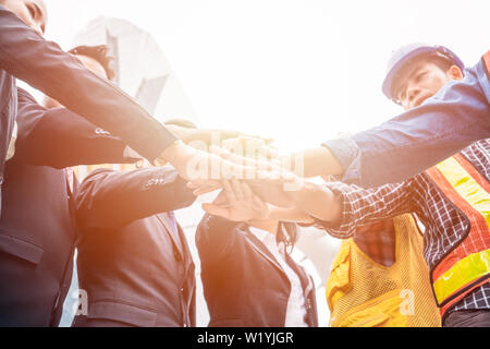 Group of business person with engineer are hands coordination for success the project. Teamwork concept Stock Photo