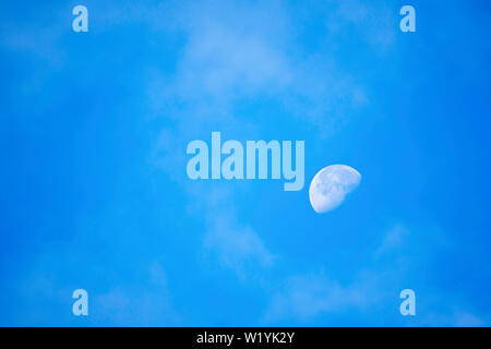 Full moon in daylight On the bright sky. Stock Photo