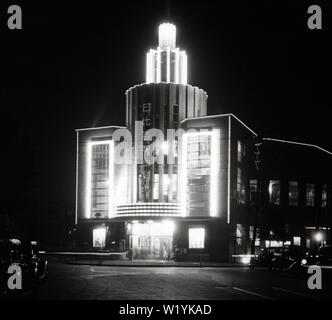 [ 1930s Japan - Hibiya Movie Theater, Tokyo ] —   An illuminated Hibiya Eiga Gekijo (Hibiya Movie Theater) at Yurakucho, Chiyodaku, Tokyo in May 1934 (Showa 9). Designed by Mikishi Abe (1883-1965) and managed by Toho Co. Ltd., the building was opened on February 1, 1934. So this photo shows the theater very shortly after its completion. It was closed in 1984 (Showa 59).  20th century vintage glass slide. Stock Photo