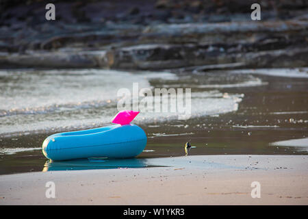 Blue Inflatable ring on the beach Background sea. Stock Photo