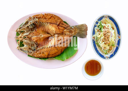 Isolated fried snapper fish With seafood sauce and vegetables  in dish on a white background with clipping path. Stock Photo