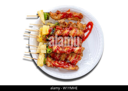 Isolated BBQ grilled Chicken with vegetables and tomato sauces on a white background with clipping path. Stock Photo