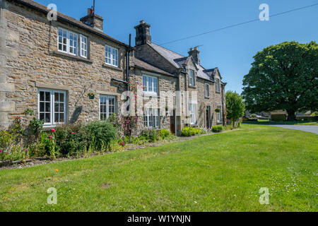 Local stone built housing in the Yorkshire Dales village of Redmire, England, UK.