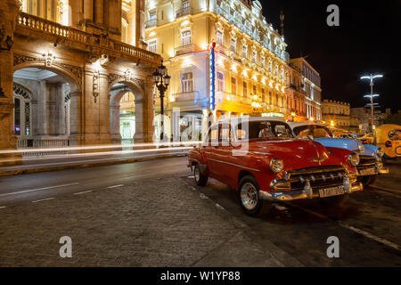 Havana, Cuba - May 17, 2019: Classic Old American Car in the streets of the Old Havana City during a vibrant night after sunset. Stock Photo