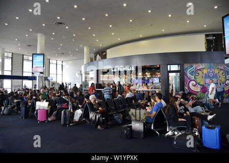 LOS ANGELES, CA, USA - JUNE 25, 2019: Travelers waiting for flights at LAX before a holiday weekend Stock Photo