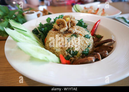 fried rice or stir-fried rice with crispy pork, duck and vegetable Stock Photo