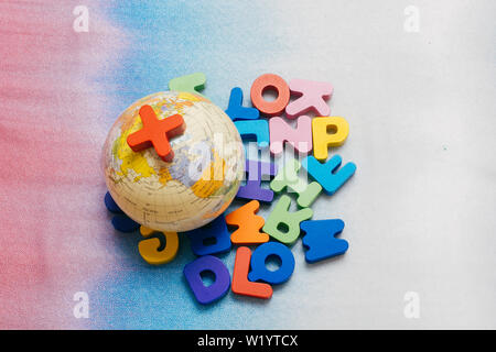 Globe model on colorful letters on a colorful background Stock Photo