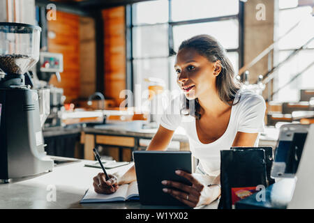 Young woman working in her cafeteria Stock Photo