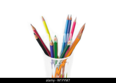 group of Multi-colored pencils in a transparent glass mug isolated on white. Stock Photo