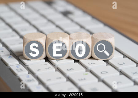 cubes with letters forming the acronym SEO on a keyboard Stock Photo