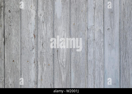 Aged wooden surface of vertical planks with cracked white paint, texture for background Stock Photo