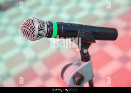 Soft focus of head microphone on stage of Student Parents Meeting in summer school or event whit blurred background,Education meeting on stage concept Stock Photo