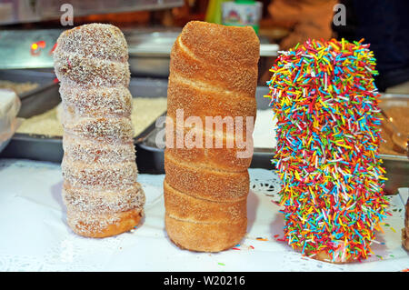 Christmas baked fragrant buns sprinkled with candies, candied fruits and chocolate on the counter at the festive fair Stock Photo