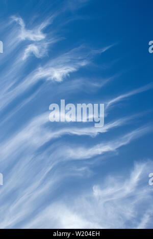 Wispy white clouds against a blue sky Stock Photo