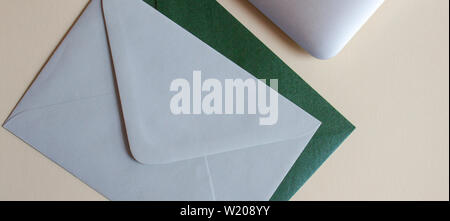 Colorful envelopes, laptop and cardboards on table. Mockup. Office concept. Stock Photo