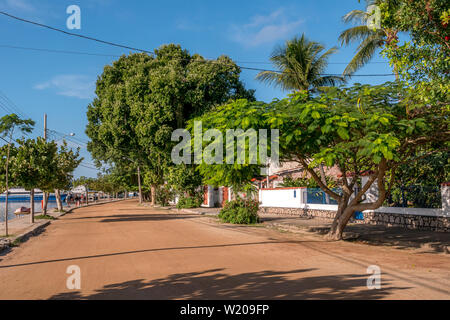 Rio de Janeiro, Brazil - June 22, 2019: street of Paqueta Island with its houses, trees and a few unrecognisable people walking on a summer day with b Stock Photo