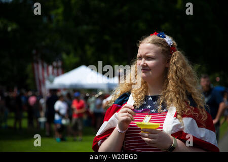 Amherst, NH, USA. 4th July, 2019. Presidential candidates marched in the 4th of July parade on July 4, 2019 in Amherst New Hampshire. They all were campaigning to voters for support. A local patriotic woman. Credit: Allison Dinner/ZUMA Wire/Alamy Live News Stock Photo