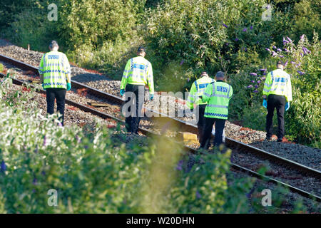 Margam, Wales, UK. 3rd July, 2019. Police officers are searching the tracks after the train which caused the accident is removed from near Margam in south Wales, UK. Wednesday 03 July 2019 Re: Two rail workers have died after being hit by a passenger train between Port Talbot Parkway and Bridgend stations in south Wales, UK. The pair were struck near Margam by the Swansea to London Paddington train at about 10am. They were pronounced dead at the scene and a third person was treated for shock, but was not injured. Credit: ATHENA PICTURE AGENCY LTD/Alamy Live News Stock Photo