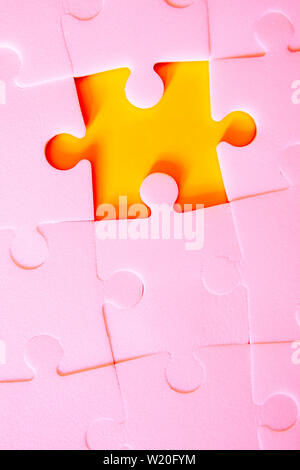 Multiple white puzzle pieces put together without one piece. View from above. Stock Photo