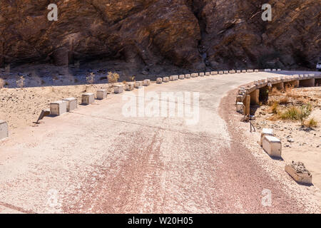 Concrete bridge over a dried up riverbed in Namibia. Stock Photo