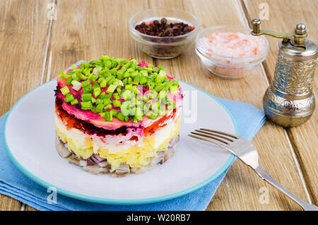 Layered salad with vegetables and herring. Stock Photo