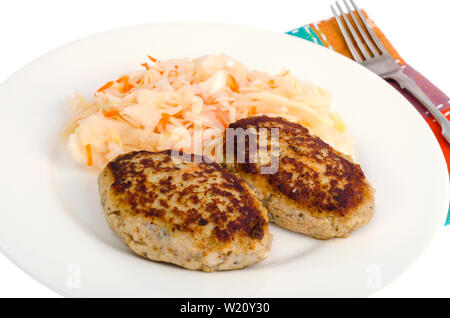 Pickled cabbage with cutlets oa white plate Stock Photo