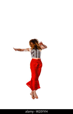 Happy girl working out dance standing with hands up. Dynamic woman fitness trainer dancing for fun Stock Photo
