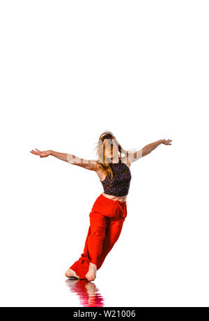 Happy girl working out dance standing with hands up. Dynamic woman fitness trainer dancing for fun Stock Photo