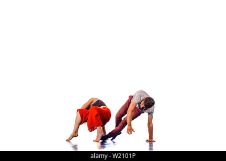 Teenagers skill and talent of modern dance, dancing in studio over white background Stock Photo