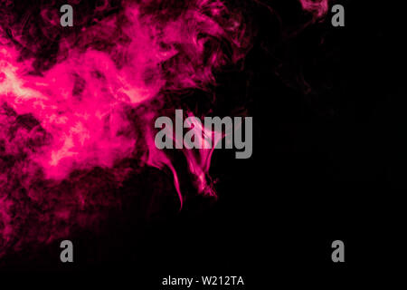 Colored background with winding clouds of smoke from patterns of different forms of pink, green and blue colors with tongues of flame on a black isola Stock Photo