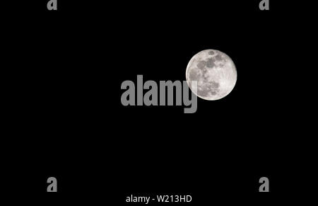The full moon in the sky at night is black. Stock Photo