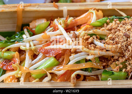 Fried noodle with spring onion and bean sprouts in bamboo. Stock Photo