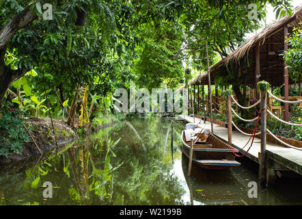 Wooden boat floating in nature water. Stock Photo