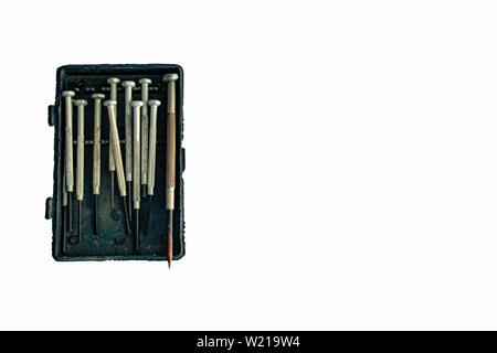 A small screwdriver in the box that is defective on a white background. Stock Photo