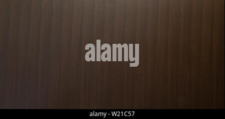 Dark brown wood panel background texture with a vertical stripe woodgrain pattern in a full frame panorama Stock Photo