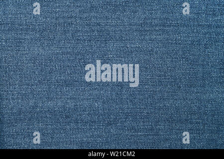 Blue jeans texture. Abstract pattern on blue jean background. Canvas denim texture. Material background. Dark backgrounds. Clothing design. Stock Photo