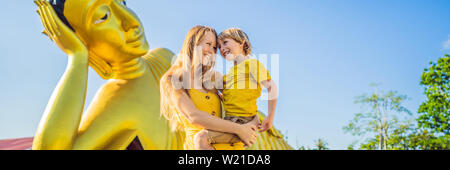 Happy tourists mother and son on background ofLying Buddha statue BANNER, LONG FORMAT Stock Photo