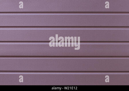 Soft pink striped steel surface. Strip pattern on the metal door. Reflecting metallic cladding of wall, texture. Ribbed rose-color background. Iron su Stock Photo