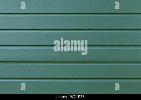 Reflecting metal convex texture in lines. Green metallic ribbed surface. Abstract pattern. Metal shutters backdrop. Green background of steel plate. M Stock Photo