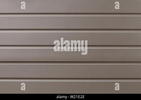 Light brown metallic ribbed surface. Abstract pattern. Beige metal backdrop. Gold industrial background of steel plate. Metalline wall siding, claddin Stock Photo