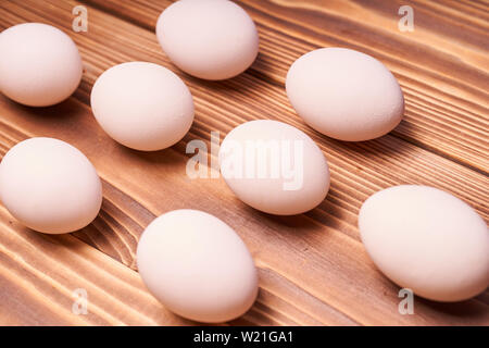 Chicken eggs laid on a wooden table. Stock Photo