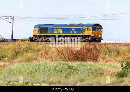 GB Railfreight Class 66 diesel electric 66776 hauling a freight train on the east coast line of Greater Anglia railway near Manningtree, Essex, UK Stock Photo