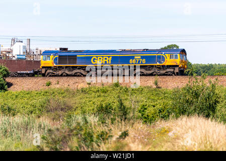 GB Railfreight Class 66 diesel electric 66776 hauling a freight train on the east coast line of Greater Anglia railway near Manningtree, Essex Stock Photo