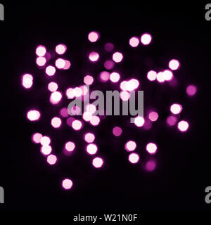 Abstraction from purple bokeh lights of hexagonal shape on black square. Stock Photo