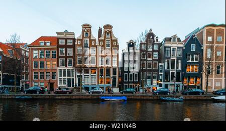 Historic row of houses on a canal at dusk, Amsterdam, North Holland, Netherlands Stock Photo