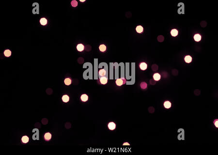Black festive background with shining hexagonal bokeh lights. Stock Photo