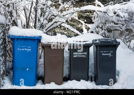 Paper bin, waste bin and bio bin, waste bins with snow, Munich, Upper Bavaria, Bavaria, Germany Stock Photo